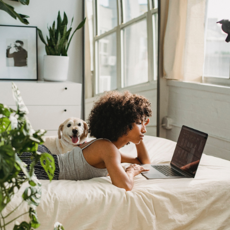 Woman laying on bed during online therapy session